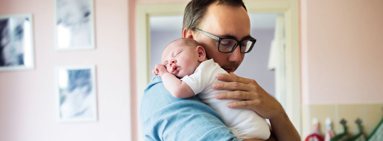 father holding baby