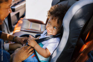 mom securing a car seat