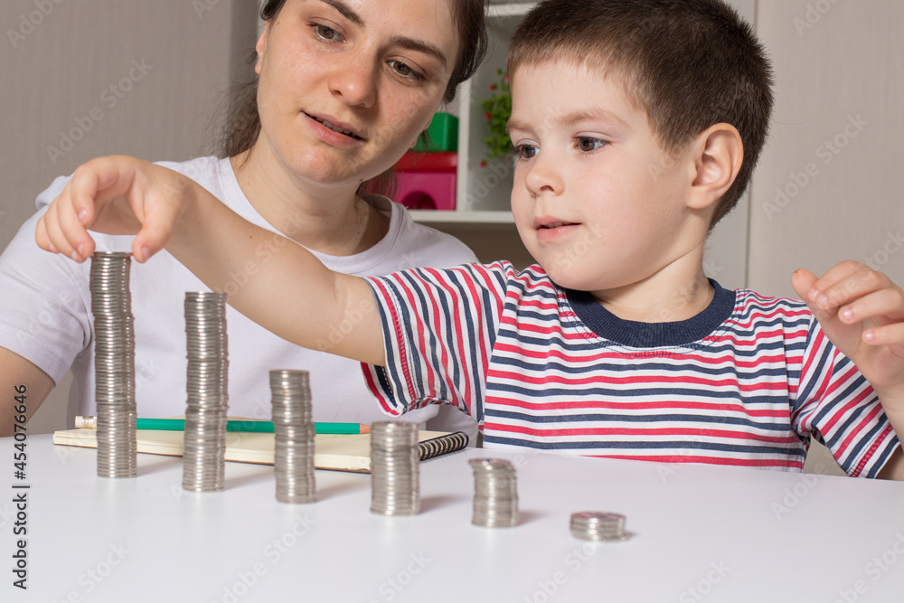 mother and son stacking coins